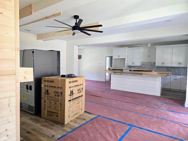 Kitchen featuring a ceiling fan, tasteful backsplash, a center island, wood finished floors, and beam​​‌​​​​‌​​‌‌​‌‌​​​‌‌​​‌‌​‌​​​​​‌ ceiling | Image 7