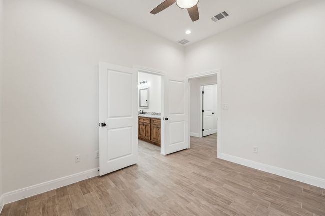 Unfurnished bedroom with baseboards, visible vents, and wood plank tile floor | Image 20