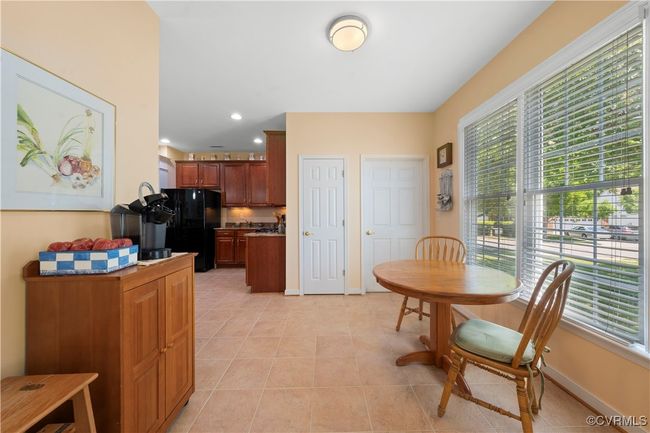 Dining space featuring healthy amount of natural light, light tile patterned flooring, and recessed lighting | Image 16