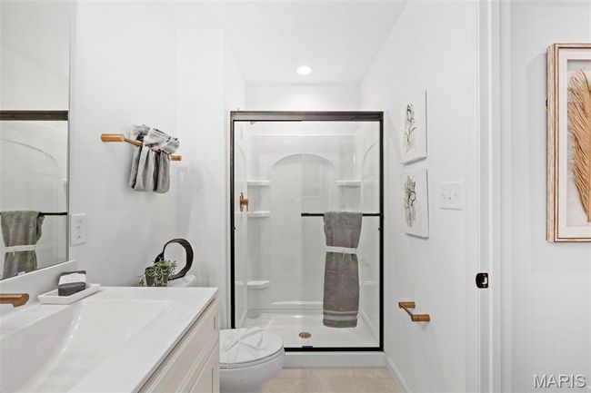 Bathroom featuring toilet, a shower stall, vanity, and recessed lighting | Image 22