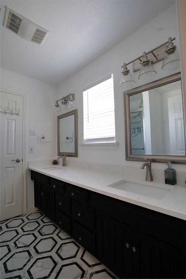 Bathroom featuring double vanity and a shower | Image 24