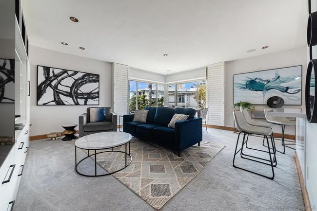 Living room looking toward ocean view floor to ceiling window. | Image 5