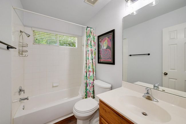 Full bathroom featuring shower / bath combo with shower curtain, vanity, and wood finished floors | Image 16