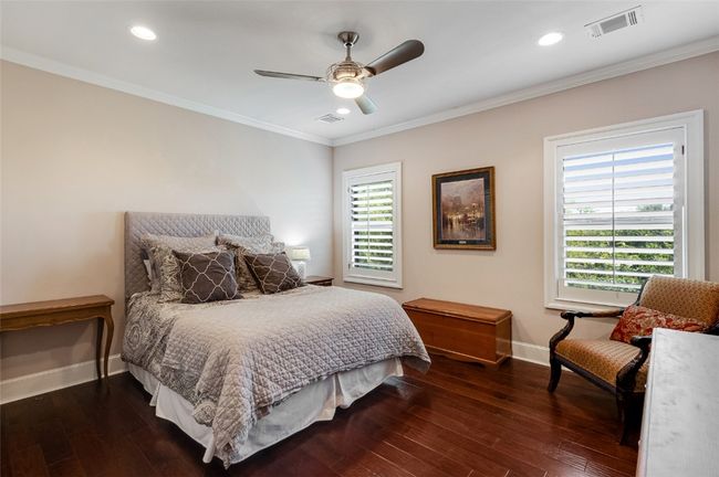 Bedroom with baseboards, ornamental molding, dark wood finished floors, recessed lighting, and ceiling fan | Image 16