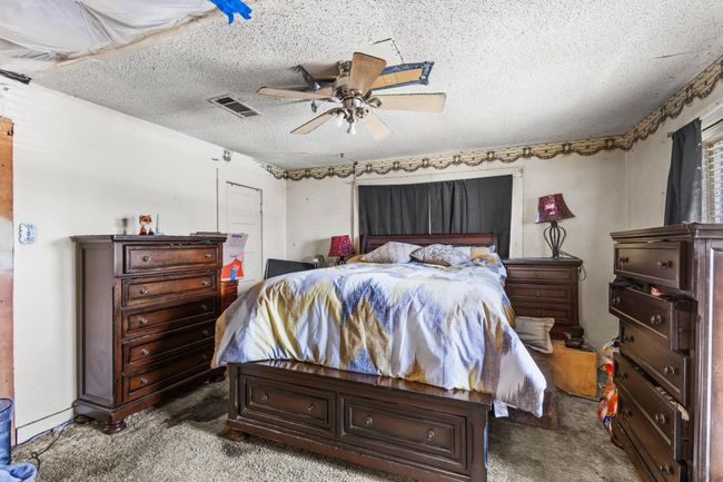 Carpeted bedroom featuring a textured ceiling and ceiling fan | Image 13