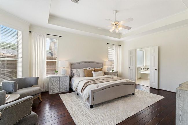 The spacious bedroom features a trayed ceiling, bay windows, and an ensuite bathroom. | Image 15