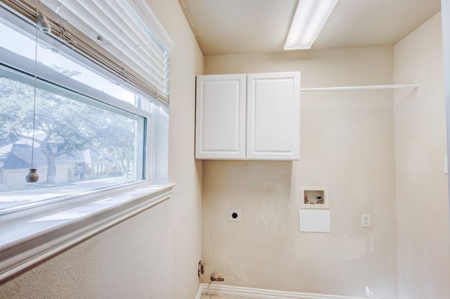 Laundry area featuring cabinets, hookup for a washing machine, and hookup for an electric dryer | Image 29