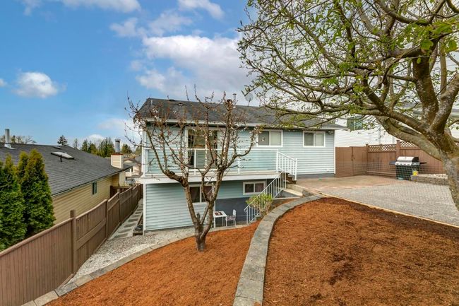 Rear view of house featuring a fenced backyard, a patio, and a shingled roof | Image 40