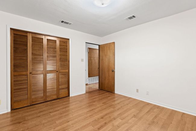 Unfurnished bedroom with light wood-style flooring and a closet | Image 20