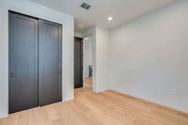 Unfurnished bedroom featuring light wood finished floors, recessed lighting, and a closet | Image 20
