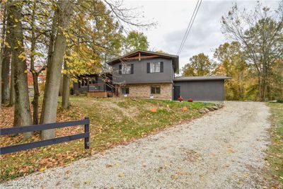 View of front facade with a wooden deck | Image 1