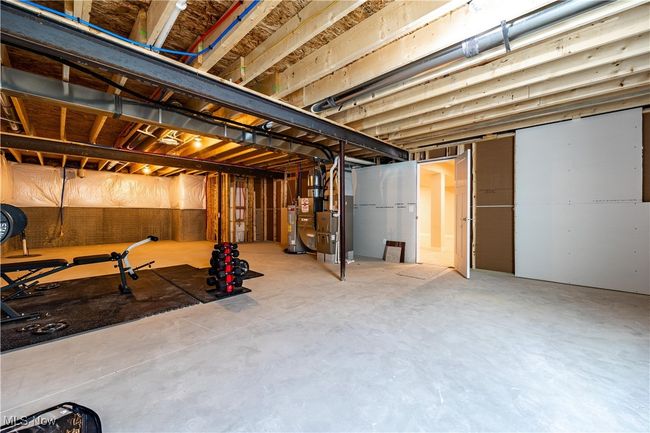 Unfinished below grade area with water heater and heating unit | Image 31