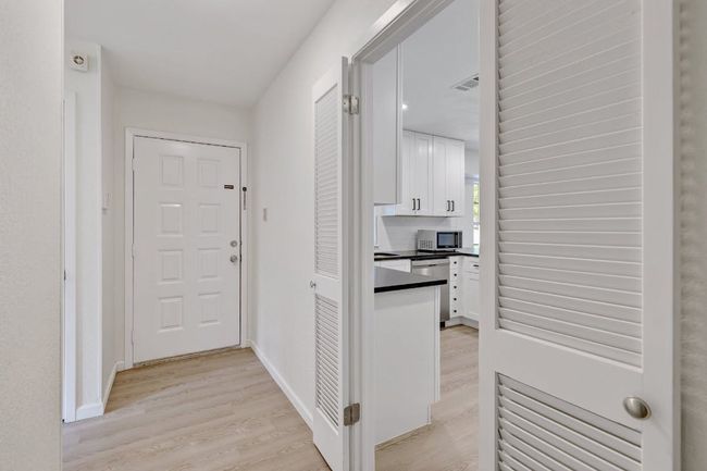 Hallway featuring light wood-type flooring and baseboards | Image 6