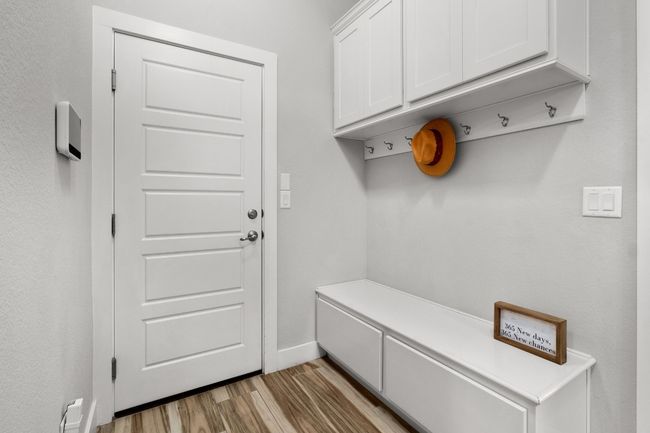 Mudroom featuring storage and entry to garage | Image 15