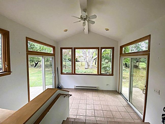 Unfurnished sunroom with baseboard heating and lots of natural light | Image 11