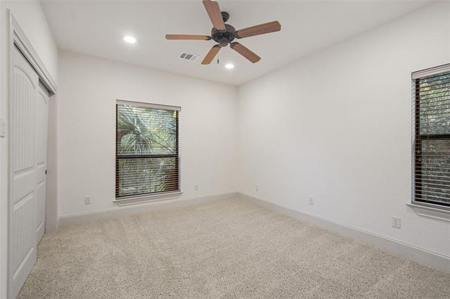 Discover the comfort of three generously-sized upstairs bedrooms, complete with modern recessed lighting, cooling ceiling fans, and ample closet space. | Image 31