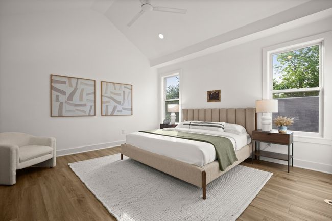 Bedroom with high vaulted ceiling, wood finished floors, a ceiling fan, and baseboards | Image 6