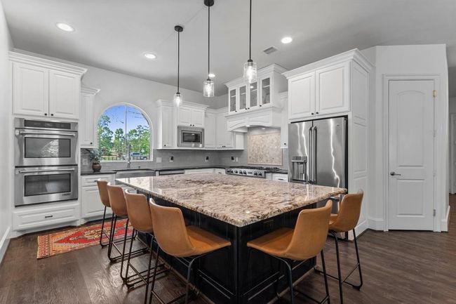 Oversized island, stainless steel appliances, fresh paint and plenty of cabinets! | Image 13