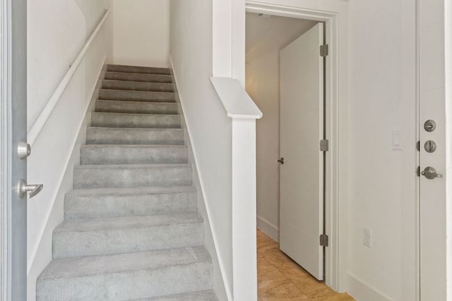 Enter directly from the garage or the parking lot into the first level, where you’ll find a convenient half bath, perfect for guests or quick stops before heading upstairs. | Image 7