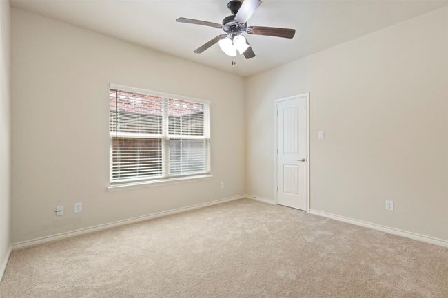 Empty room with light carpet, ceiling fan, and baseboards | Image 19
