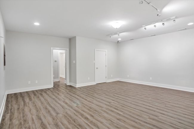 Empty room featuring light hardwood / wood-style flooring and rail lighting | Image 21