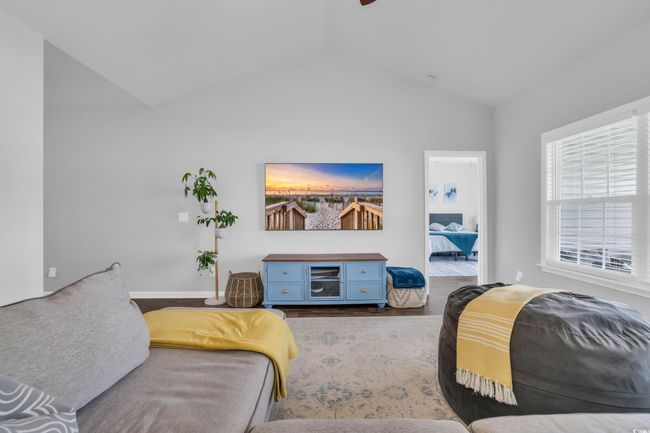 Living area with baseboards, vaulted ceiling, and wood finished floors | Image 19