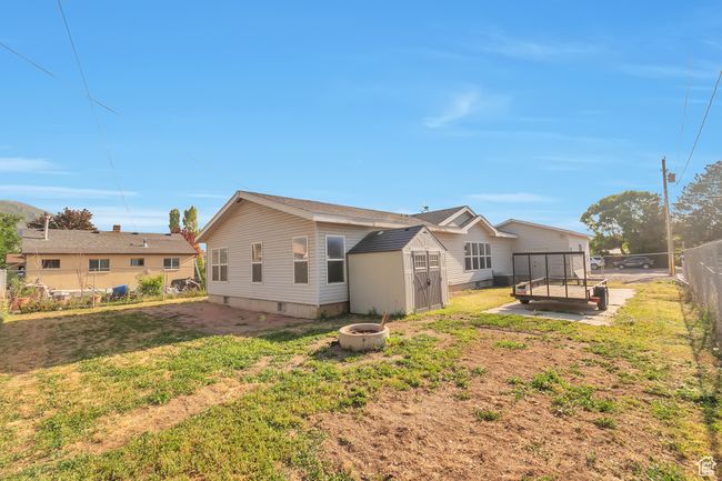 Back of property with a fire pit and crawl space | Image 23