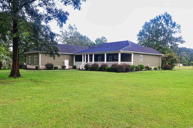 Ranch-style home with a front lawn and a sunroom | Image 27