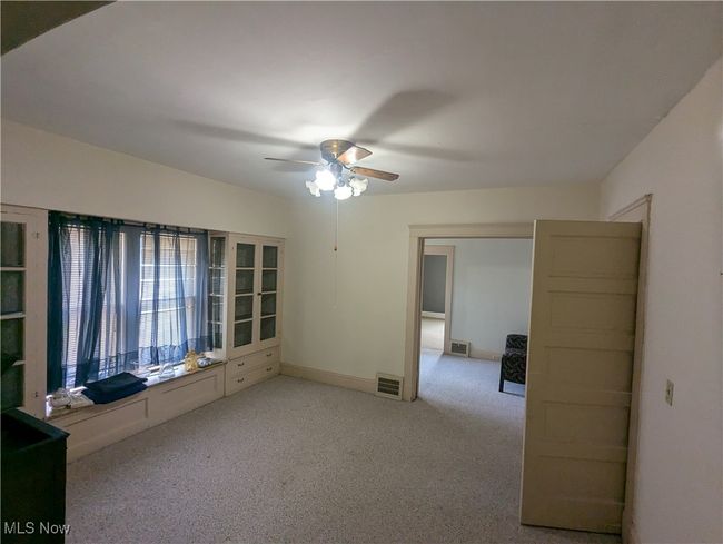 First-Floor Dining Room with ceiling fan and light colored carpet | Image 7