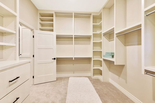 Walk in closet featuring light carpet | Image 26