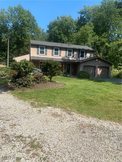 View of front property featuring a garage and a front yard | Image 1