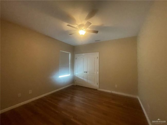 Spare room featuring wood finished floors and a ceiling fan | Image 8
