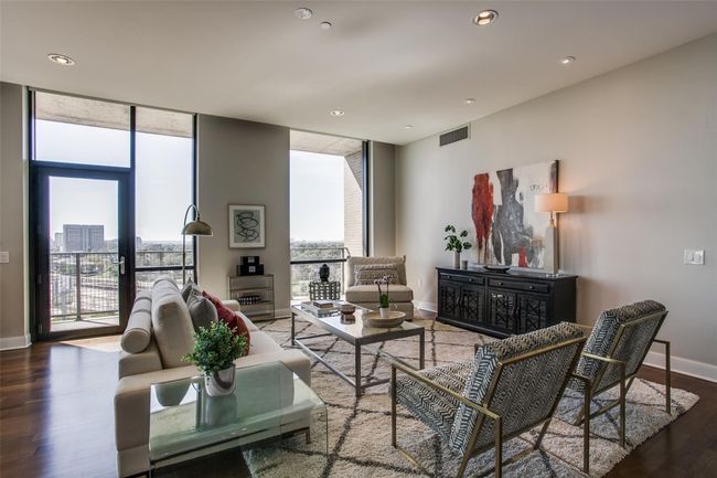 Wood floors, wall of windows & balcony access. | Image 8