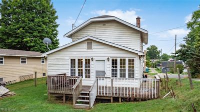 Rear view of property with a deck and a lawn | Image 3