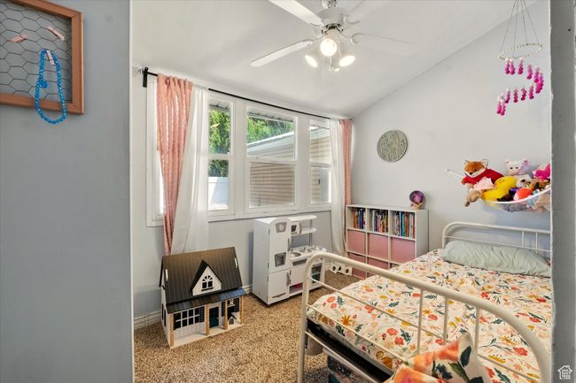 Carpeted bedroom with lofted ceiling and ceiling fan | Image 15