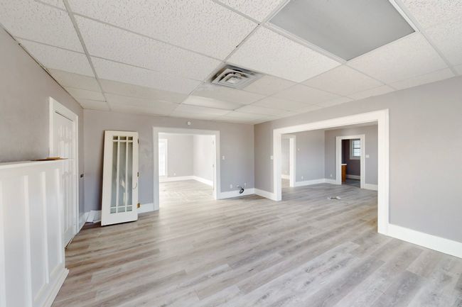 Unfurnished room with light hardwood / wood-style floors and a paneled ceiling | Image 9