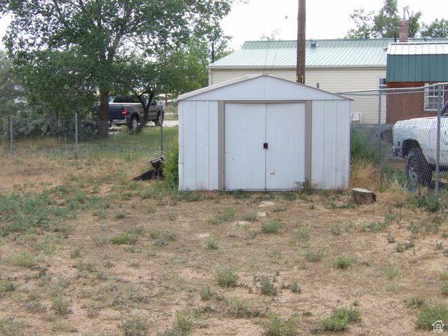 Storage shed located in backyard. | Image 43