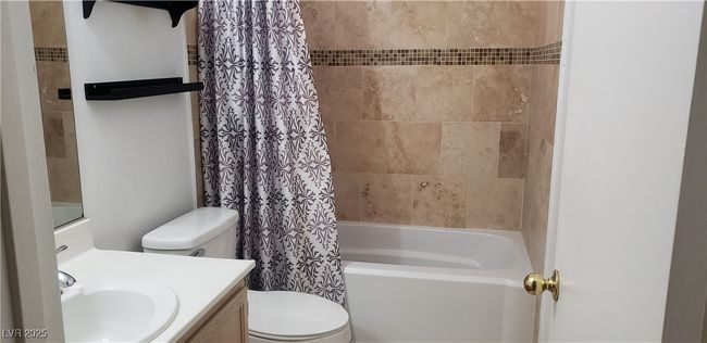 Full bathroom with shower / bath combo with shower curtain, vanity, and toilet | Image 8