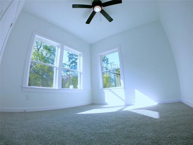 Carpeted empty room featuring a ceiling fan and baseboards | Image 15