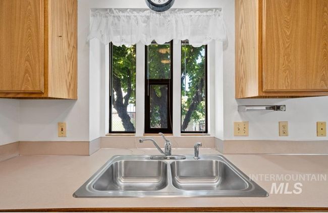 Kitchen with light countertops and a sink | Image 8