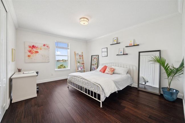 Spacious 3rd floor bedroom with water view. Closet is oversized and includes built-in shelves and drawers. | Image 66