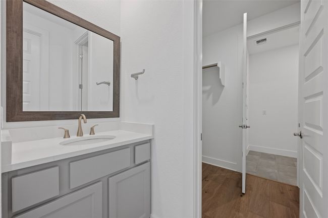 Bathroom featuring wood finished floors, vanity, and baseboards | Image 17