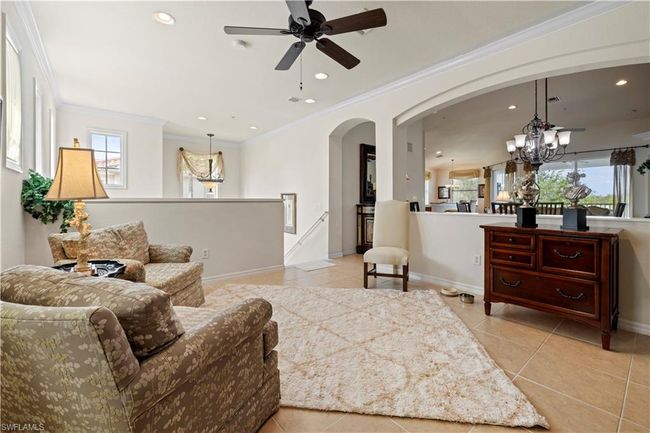 loft area featuring arched walkways, light tile patterned floors, and a wealth of natural light | Image 7