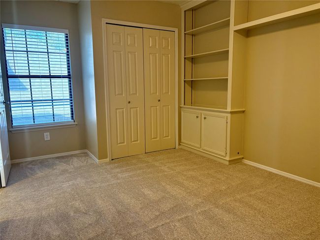 Unfurnished bedroom featuring light carpet, baseboards, and a closet | Image 17