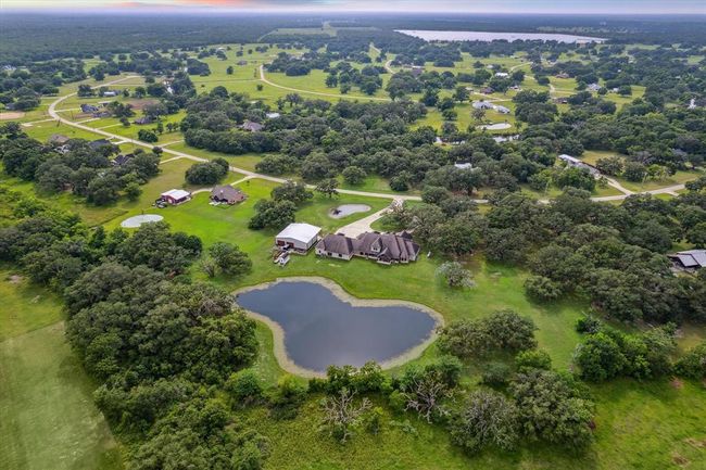 Set on 5 acres, this property is a nature lover's paradise, featuring century-old oak trees and two tranquil ponds. The land is teeming with an abundance of wildlife, including deer, bobcats, rabbits, bald eagles, cranes, owls, hawks, foxes, and more. Witness these incredible animals in their natural habitat on a daily basis, offering a serene and ever-changing outdoor landscape. Perfect for those seeking privacy and the beauty of nature right outside their door. | Image 47