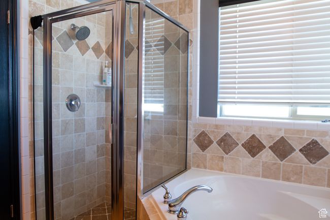 Primary Bathroom featuring a bath and a shower stall | Image 15
