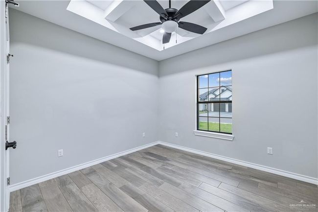 Unfurnished room featuring wood finished floors and ceiling fan | Image 8