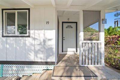 Enjoy your morning or evening beverage on your covered front lanai. | Image 3