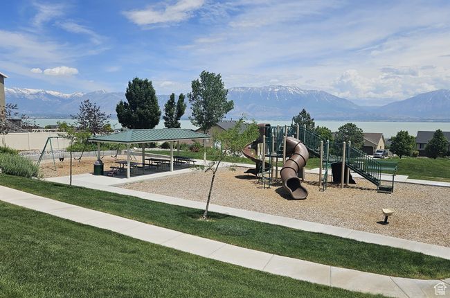 Community jungle gym with a mountain view, a gazebo, and a lawn | Image 31