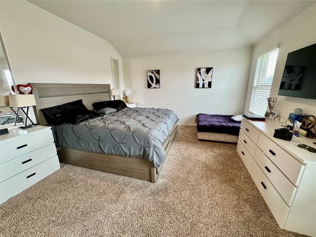 Bedroom with lofted ceiling and carpet floors | Image 6